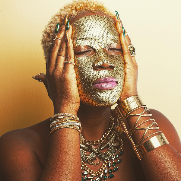 Black woman wearing sheet mask
